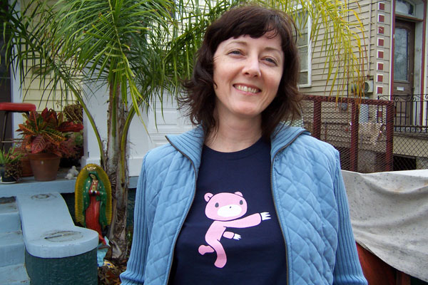 photo of Ana wearing a Gloomy Bear t-shirt in front of our house